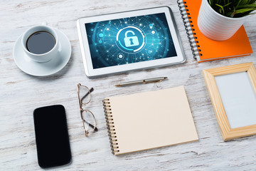 Web security and technology concept with tablet pc on wooden table