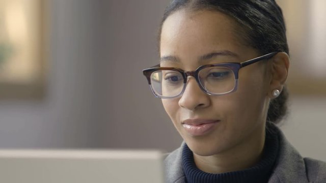 Portrait of a young black female working on a computer