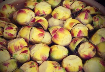 clean bottoms of artichokes prepared by the cook