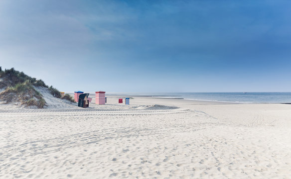 North Sea beach with beach chairs and a blue sky