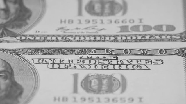 Hundred-dollar bills close-up, motion slider. Macro photography of banknotes.