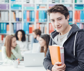 Student posing with books