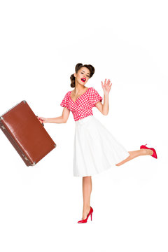 beautiful young woman in retro clothing with suitcase isolated on white