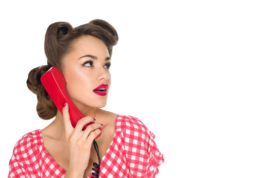 portrait of pin up woman talking on old telephone isolated on white