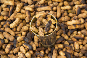 Steel glass full with fried groundnuts for sale, Narayanpur