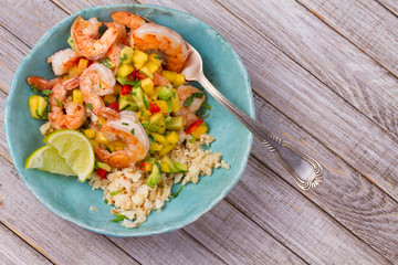 Shrimps with mango avocado and red pepper salsa on cauliflower rice