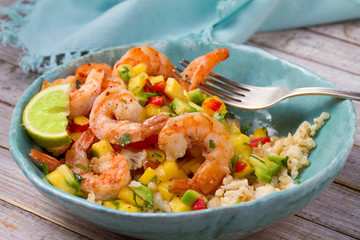 Shrimps with mango avocado and red pepper salsa on cauliflower rice