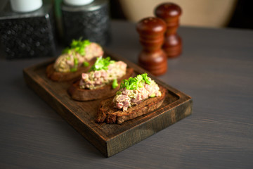 bruschetta, on slices of toasted baguette garnished with basil