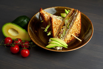 Top view of Healthy Sandwich toast with lettuce, ham, cheese and tomato on a wooden background