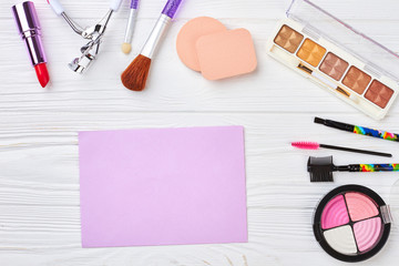 Fototapeta na wymiar Makeup cosmetics and equipment. Blank paper sheet. Work space of visagiste.