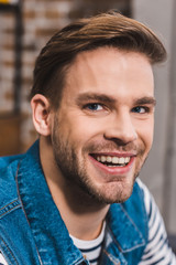Fototapeta premium close-up portrait of handsome young man smiling at camera