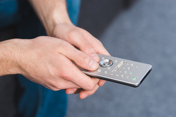 cropped shot of man using remote controller