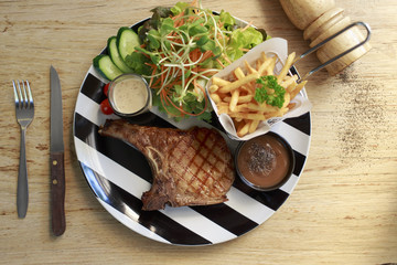 Top View Grilled steaks and vegetable salad. Steak porkchopblackpepper.