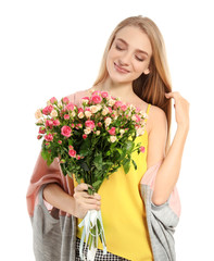 Beautiful young woman with bouquet of roses on white background