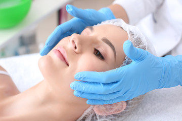 Fototapeta na wymiar Young woman undergoing beauty procedure in salon