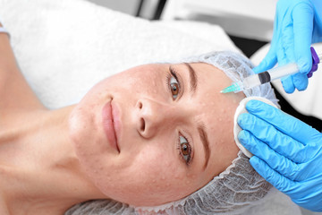 Obraz na płótnie Canvas Beautician making injection in woman's face, closeup. Biorevitalization procedure