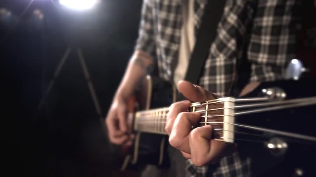 the guitarist plays the guitar. fretboard closeup.