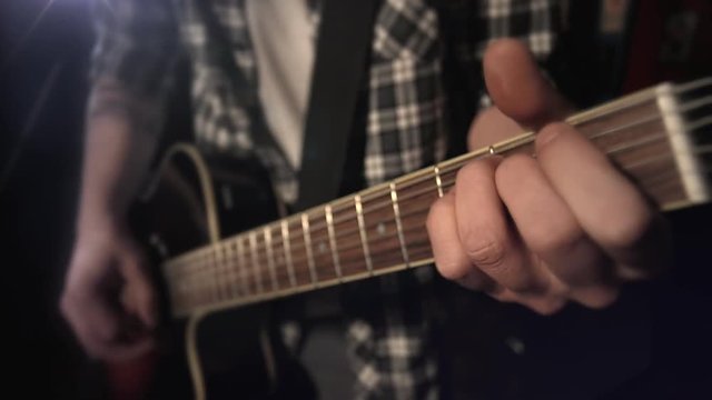 the guitarist plays the guitar. fretboard closeup.