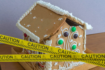 Ruined gingerbread house behind a police tape. Ruined walls, mortgage, credit, bankruptcy.