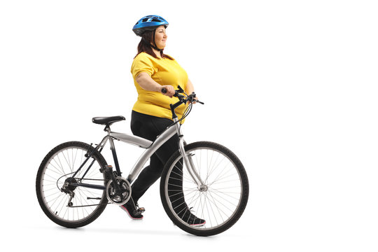 Overweight woman pushing a bicycle
