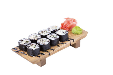 Sushi set on a wooden board, isolated.