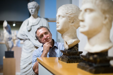 male evaluates the exhibition in the historical museum