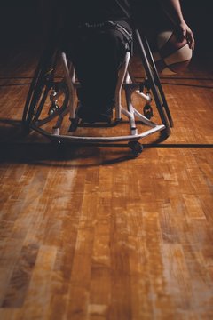 Disabled man practicing basketball in the court