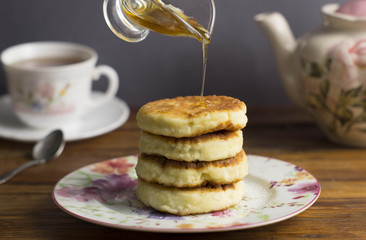 Cheese cakes, tea, honey, pancakes