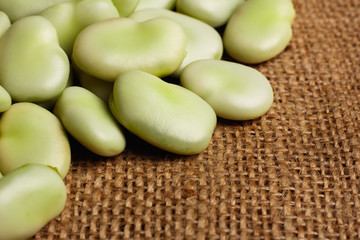 fresh broad beans on a rustic background