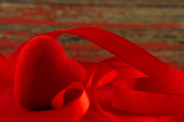 Valentine's Day. Red heart and red ribbon, as a symbol of the holiday.