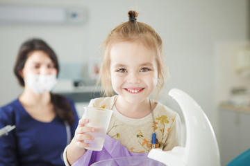 Little child happy after painless teeth polishing procedure