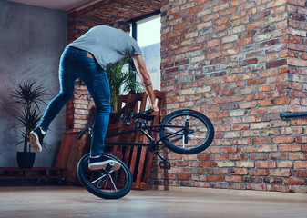 A handsome man with BMX in a studio.
