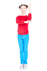 Portrait of cute Asian school girl in red sweater and blue jeans with double buns on her head posing on white background