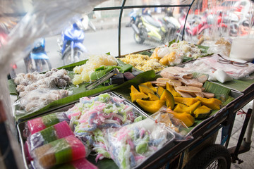 Thai traditional dessert, steamed pumpkin and Pisang Awak banana on a mobile cart, Kingpetch market, Bangkok, Thailand