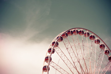 Vintage style Ferris wheel with blue sky