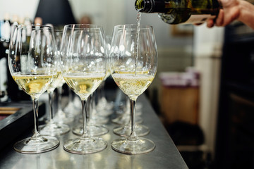 waiter brings glasses of champagne