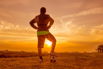 silhouette football player at sunset or sunrise background