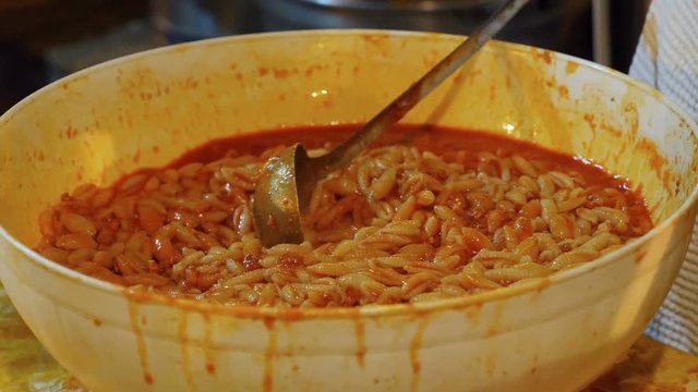 Homeless Canteen : serving hot pasta with sauce to poor people
