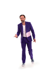 Full length portrait of a smiling man in clown suit on white background.