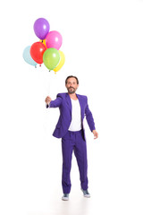 Handsome man in blue suit and white T shirt. Holding balloons.
