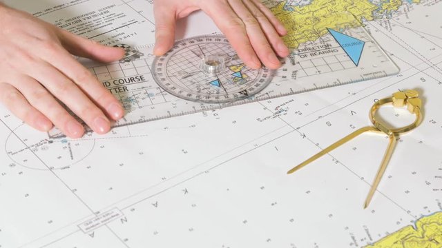Person plotting course for trip by the sea.