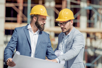 Construction specialist and worker outdoors.