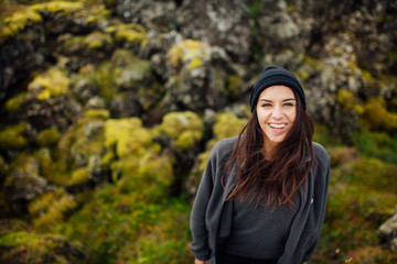 Young peaceful woman enjoying view of the moss covered meadows in Iceland.Arctic circle wild...