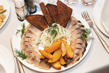 herring with bread and potatoes
