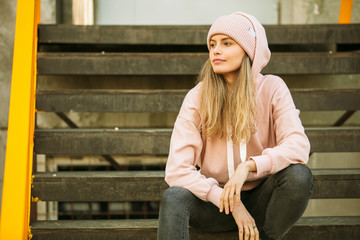 cool young woman in pink hoodie
