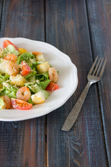 Caesar salad with shrimps, cherry tomato, croutons, salad leaf and parmesan cheese