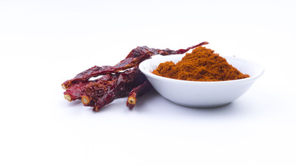 Red Chilly Powder in a bowl on white background. Selective focus and crop fragment.