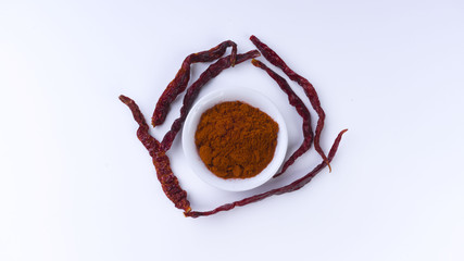 Red Chilly Powder in a bowl on white background. Selective focus and crop fragment.