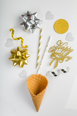 Birthday concept - silver and gold decorations on white background