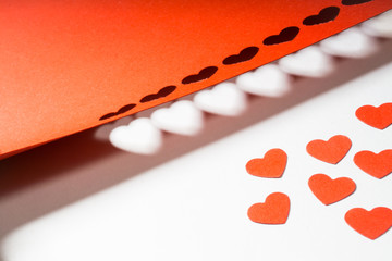 Decoration for Valentine's Day: hole puncher made paper shapes of red hearts